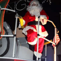 <p>Mario Izzo as Santa Claus on the back of a Park Ridge Fire Department truck.</p>