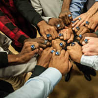 <p>Members of the Berkeley College men’s basketball team show their championship rings during a ring ceremony in midtown Manhattan.</p>