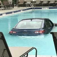 <p>A woman hit the gas instead of the brake and ended up in a pool.</p>