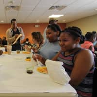 <p>Kids enjoy a celebration of summer meals in the community room of the Martin Luther King Jr. Apartments in Stamford.</p>