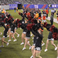 <p>Glen Rock cheerleaders pump up the crowd during the state football finals game against Mahwah Friday, Dec. 4. </p>