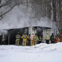 <p>Rhinebeck firefighters battle a mobile home fire.</p>