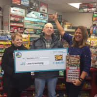 <p>Ossining resident Leon Greenberg and his wife show off their $7 million Lottery winning.</p>