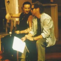<p>Dennis Bell (r) sits with Bono</p>