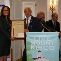 <p>Laura Desmarais, president of the Pantry, receiving the award from Francis T. Corcoran, Westchester County Legislator.</p>