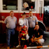 <p>Future firefighter A.J. Kaoukakis and his mom, Liz are welcomed by Chief Bill Bahr, and assistant chiefs Bill Nikisher and Jay Kinash.</p>