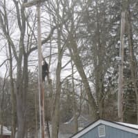 <p>Firefighter Stan Zalesny climbs the pole to accept the siren in its perch.</p>