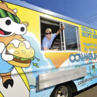 <p>Benjamin Boger in his Norwalk-based Cowabunga food truck.</p>