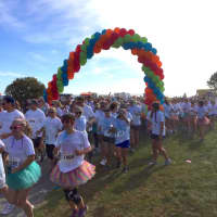 <p>An arch of color greets the runners at the start of the Colorflash at Sherwood Island State Park in Westport. </p>