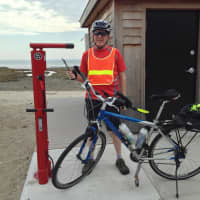 <p>Tim Bezler of Fairfield examines the town’s new stainless steel, tamperproof Bicycle Repair and Air Pump Station at Southport Beach. A second station is in place at Brookside Park near Mill Plain Road.</p>