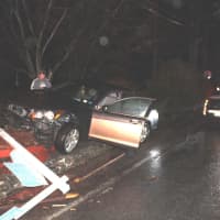 <p>A car landed on top of a brick wall after the driver lost control of his car.</p>