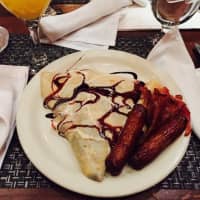 <p>Vintage&#x27;s sweet, chocolate-drizzled crepe with a side bacon and sausages is a popular entree.</p>