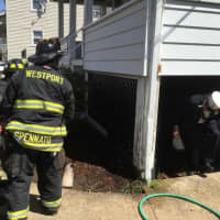 <p>Westport firefighters attack a porch blaze Tuesday morning on Franklin Street.</p>