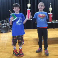 <p>Reese Axelrod, left, and Daniel Babayev, members of Ward Checkmates, celebrate their wins in a recent scholastic contest at the William B. Ward Elementary School in New Rochelle.</p>