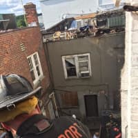 <p>Westport firefighters help two workers injured in the collapse of scaffolding at the Bedford Square construction site on Wednesday afternoon.  </p>