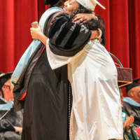 <p>A students gets a diploma and a hug.</p>