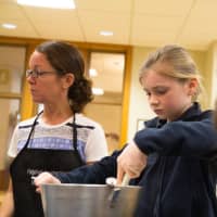 <p>Students make yogurt Tuesday at Ridgefield Academy. Jill Summer, the school&#x27;s kitchen and garden consultant and a certified chief, monitors the students.</p>