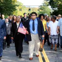 <p>Senator Terrence Murphy, Colette Carpenter and Christian Carpenter lead procession down the Major Clayton Carpenter Highway in Yorktown.</p>