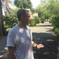 <p>Resident Mark Bowen speaks with State Sen. David Carlucci. Bowen said the abandoned house up the street hasn&#x27;t posed any problems in the last couple years.</p>