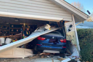 Driver Trapped After BMW Crashes Through Garage In Maryland