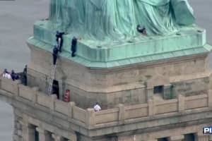 Police Grab Woman After Statue Of Liberty Protest Climb