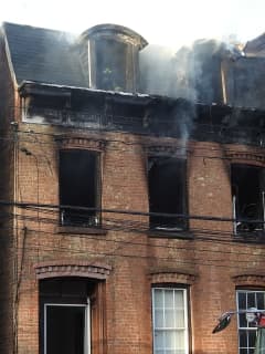 Police Officer Rescues Man Trapped On Roof During Apartment Fire In Area