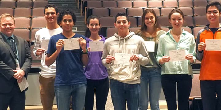 Dillon Bogart, Andrew Carton, Ella Eisinger, Amr El-Azizi, Phillip Milana, Sarah Ryan and Mihoko Sakanaka with their letters of recommendation. Allison Karantzsis, another recipient is not in the picture. Principal Steven Siciliano is at left.
