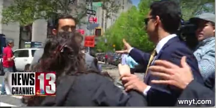 A video by News Channel 13/WNYT in Albany appears to show Billy Skelos grab the wrist of a New York Daily News reporter and throw her cell phone across the street outside the courthouse in Manhattan.