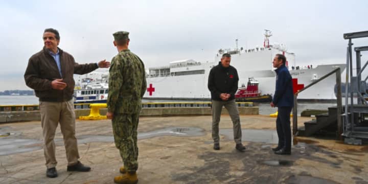Gov. Andrew Cuomo, left, and State Health Director Dr. Howard Zucker, far right, with officials at New York Harbor as the 1,000-bed US Navy Hospital Ship Comfort arrives late Monday morning, March 30 before docking at Pier 90.
