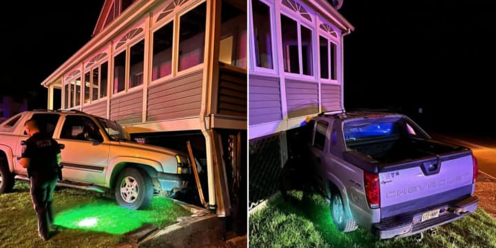 A pickup truck barreled into a Sussex County home before dawn Friday, authorities said.