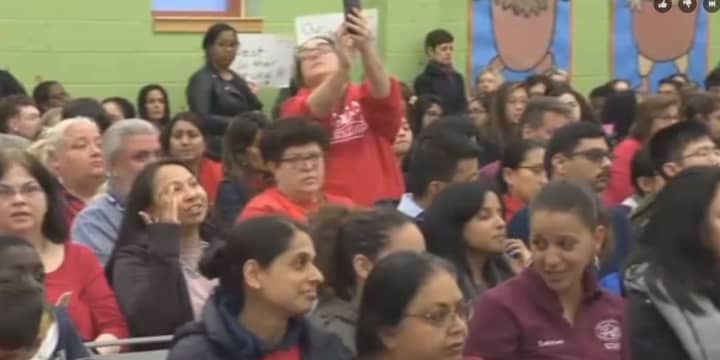 Several dozen people attended the Jersey City school board meeting Monday night to protest proposed staff cuts.