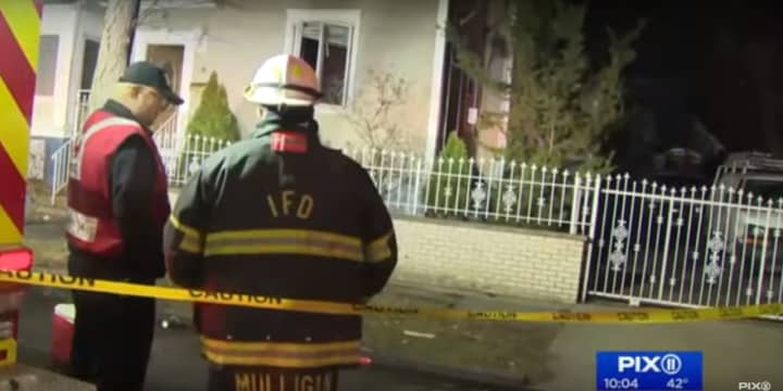 Firefighters at the scene of an Irvington blaze that left a woman dead Sunday