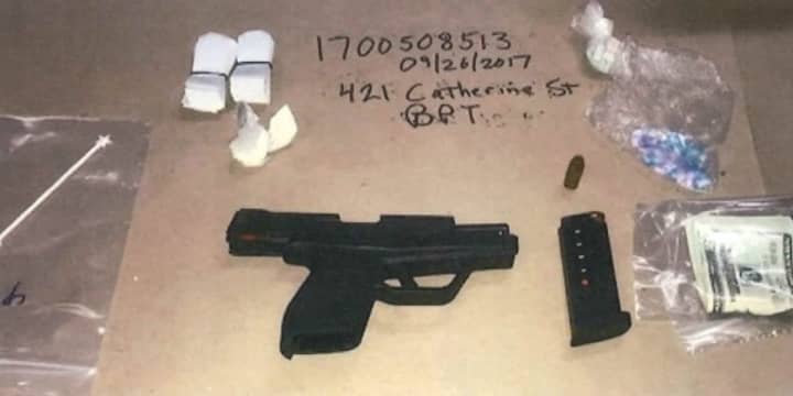 Guns, drugs and cash were seized during a raid that netted nine arrests in Bridgeport.