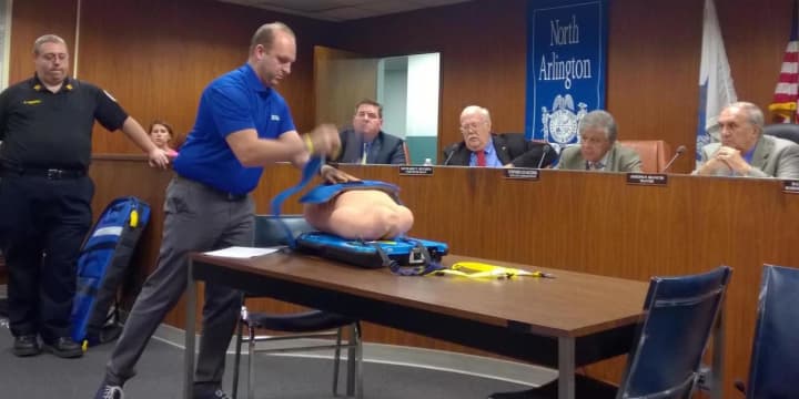ZOLL Medical&#x27;s Roi Klipper demonstrates to the North Arlington Borough Council how the NAVES AutoPulse Resuscitation System works. NAVES used the AutoPulse to save a man&#x27;s life the day it went into service.