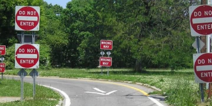 Double-posted Do Not Enter and Wrong Way signs on an exit ramp.