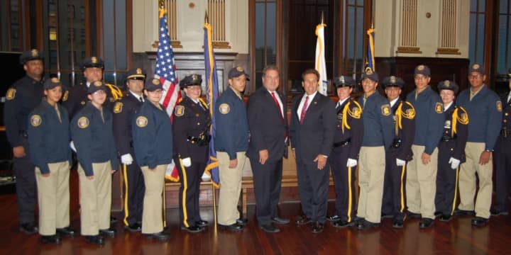 Sgt. Gabriel Barahona is pictured at extreme left, and Detective William Celestino is at extreme right. 