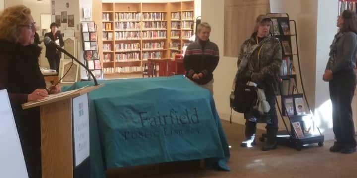 Town Librarian Karen Ronald address a large crowd gathered in the Fairfield Public Library&#x27;s Lobby before revealing this year&#x27;s selection.