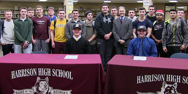 Harrison High School football players Drew Estes and Christian LoDolce recently signed Letters of Intent to play in college.