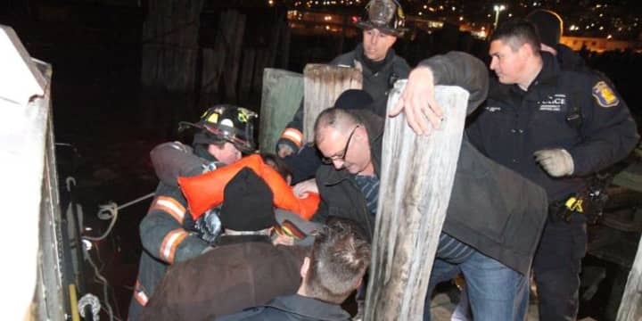 Emergency service personnel take one of the victims off a rescue boat Sunday evening  after a plane crashed in the Hudson River. 