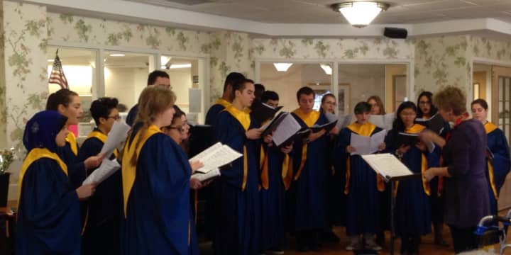 Cindy Verost directs the Saddle Brook High School choir at a nursing home performance in early December.