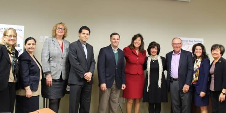State Sen. Sue Serino, fifth from right in red suit, and Dutchess County Executive Marc Molinaro, sixth from right, join health and other officials in Poughkeepsie recently to announce the &quot;Don&#x27;t Mess With Stress&quot; initiative.