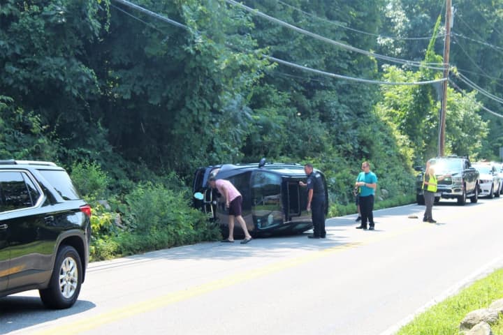 Driver, Passenger Treated By Paramedics After BMW SUV Rolls Over In Putnam