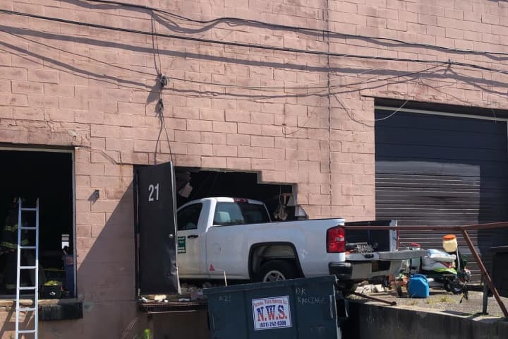 Pickup Truck Crashes Into Building In Holtsville, Injuring Two Employees