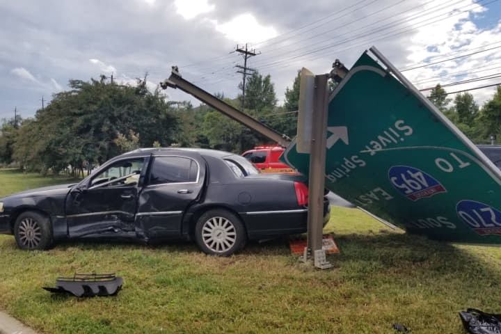 Bethesda Vehicle Collision Knocks Over Massive Road Sign, Entraps At Least One