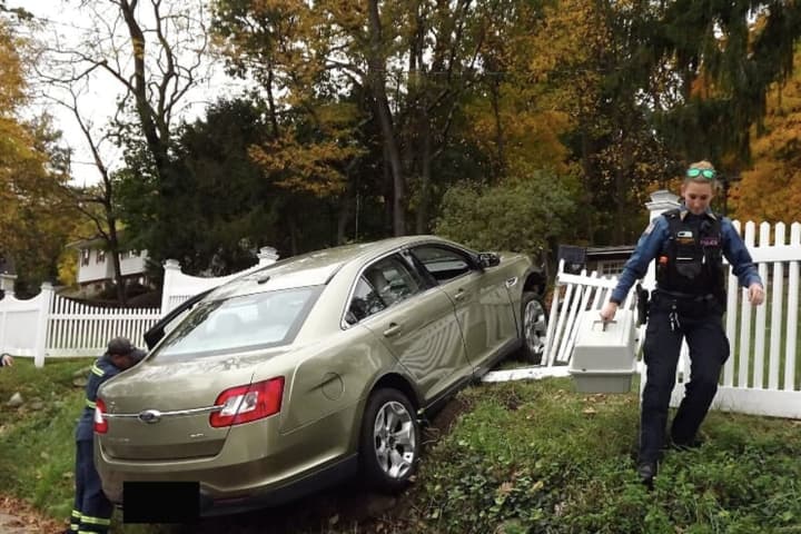 PHOTOS: Car Plows Through White-Picket Hawthorne Fence