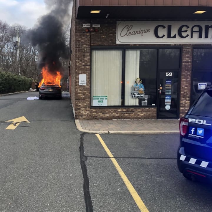 A car fire at a Rockland shopping center destroyed the vehicle and damaged one business.