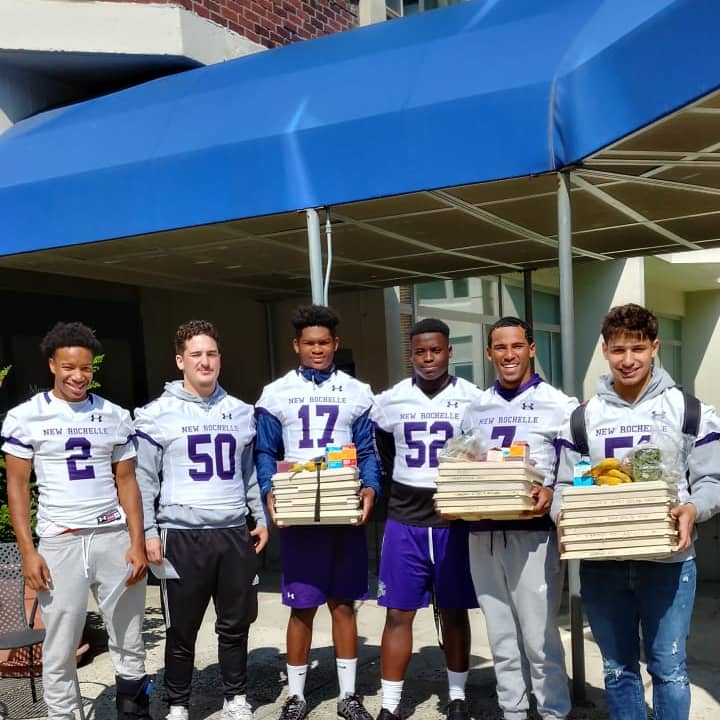 Players from the New Rochelle Varsity football team delivering meals to patients at Montefiore Hospital.