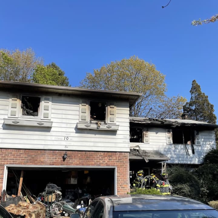 A woman was rescued by fast-acting first responders in Nassau County when a massive house fire gutted a Searington home.