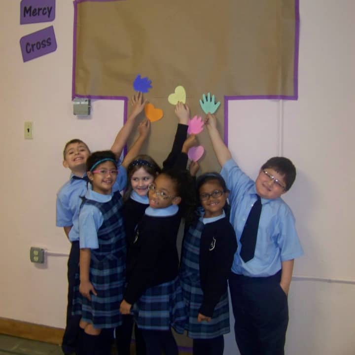 Students at Visitation Academy are encouraged to fill Mercy Cross with hearts and hands full of Works of Mercy.