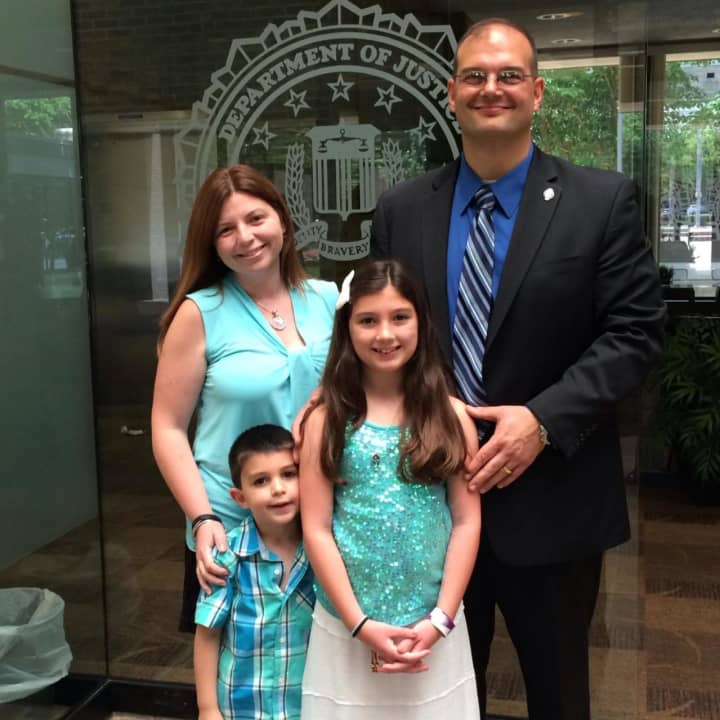 East Rutherford Police Captain Phil Taormina receives his diploma from the FBI National Academcy with his family.